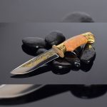 Luxurious knife on black stones