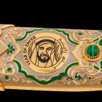 Gold emblem "Year of Zayed" on a luxurious handmade knives. The scabbard is decorated with green crystals.