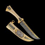 Luxurious oriental handmade knife. A gift for a strong man. The knife is decorated with jewelry stones, gold plating, the image of a wolf on a sheath, as well as manual engraving on metal.