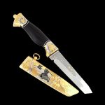 Japanese knife with the image of a samurai on a gold scabbard. Luxury gift knife