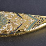 Gold scabbard manually decorated with metal carvings and art coloring
