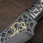 The blade is made of Damascus steel decorated with a Golden drawing of a mammoth. Author's work by Tatiana Sultanova