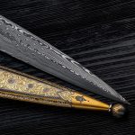 Art Damascus blade on black wood.