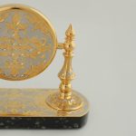 Gold watch case on a stone base