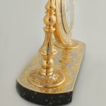 Gold table clock decorated with engraved pattern