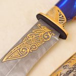 gold ornament on the blade of a knife