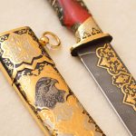 Damascus steel knife with gold ornaments and falcon scabbard