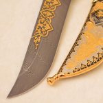 Damascus steel knife with gold ornaments and falcon scabbard