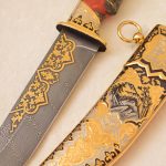 Damascus steel knife with gold ornaments and falcon scabbard