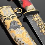 Damascus steel knife with gold ornaments and falcon scabbard