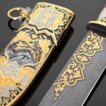 Damascus steel knife with gold ornaments and falcon scabbard