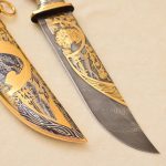 Damascus steel knife with gold ornaments and falcon scabbard