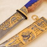 Damascus steel knife with gold ornaments and falcon scabbard