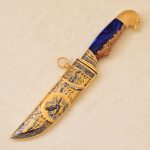 Golden knife with a falcon's head on the handle