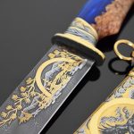 Damascus steel knife with gold ornaments and falcon scabbard