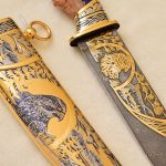 Damascus steel knife with gold ornaments and falcon scabbard