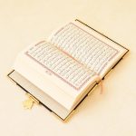Open quran in hard gold cover