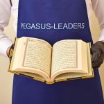 An open Quran against the background of the Pegasus Leaders brand