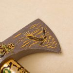 Enamelled Damascus steel ax