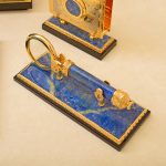 Magnifying glass made of lapis lazuli with gold coating