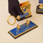 Magnifying glass made of lapis lazuli with gold coating