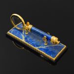 Magnifying glass made of lapis lazuli with gold coating